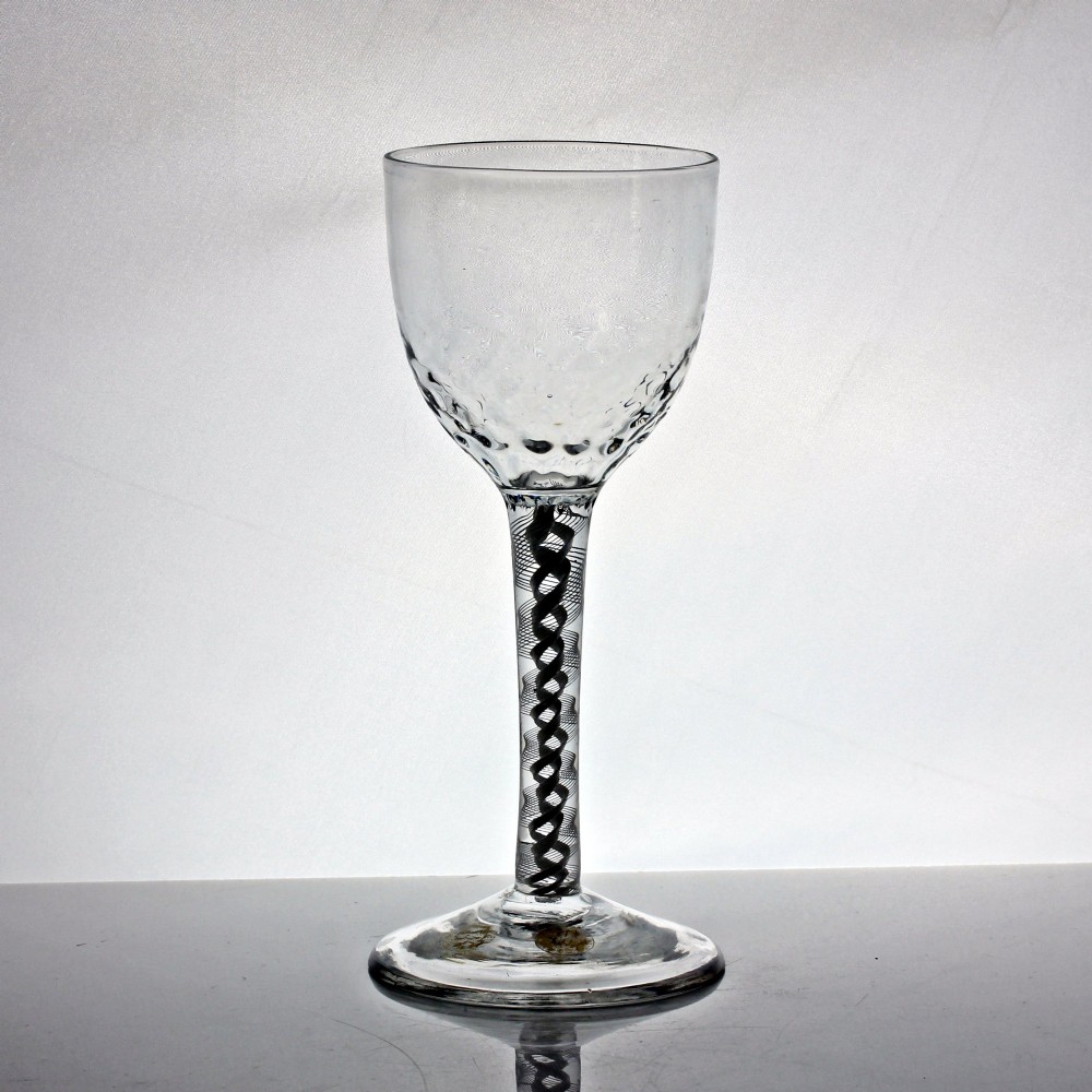 An 18th-century Georgian clear glass goblet featuring an ovoid bowl with basal mouldings, a double series opaque twist stem, and a flat conical foot. View II