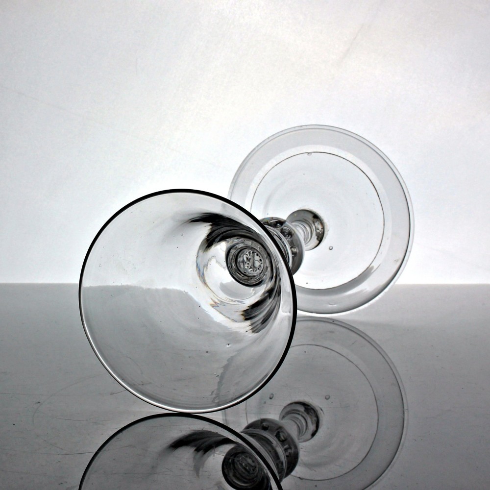 A clear Georgian glass goblet featuring a bell-shaped bowl, a turned baluster stem with knops, and a domed circular foot. View II