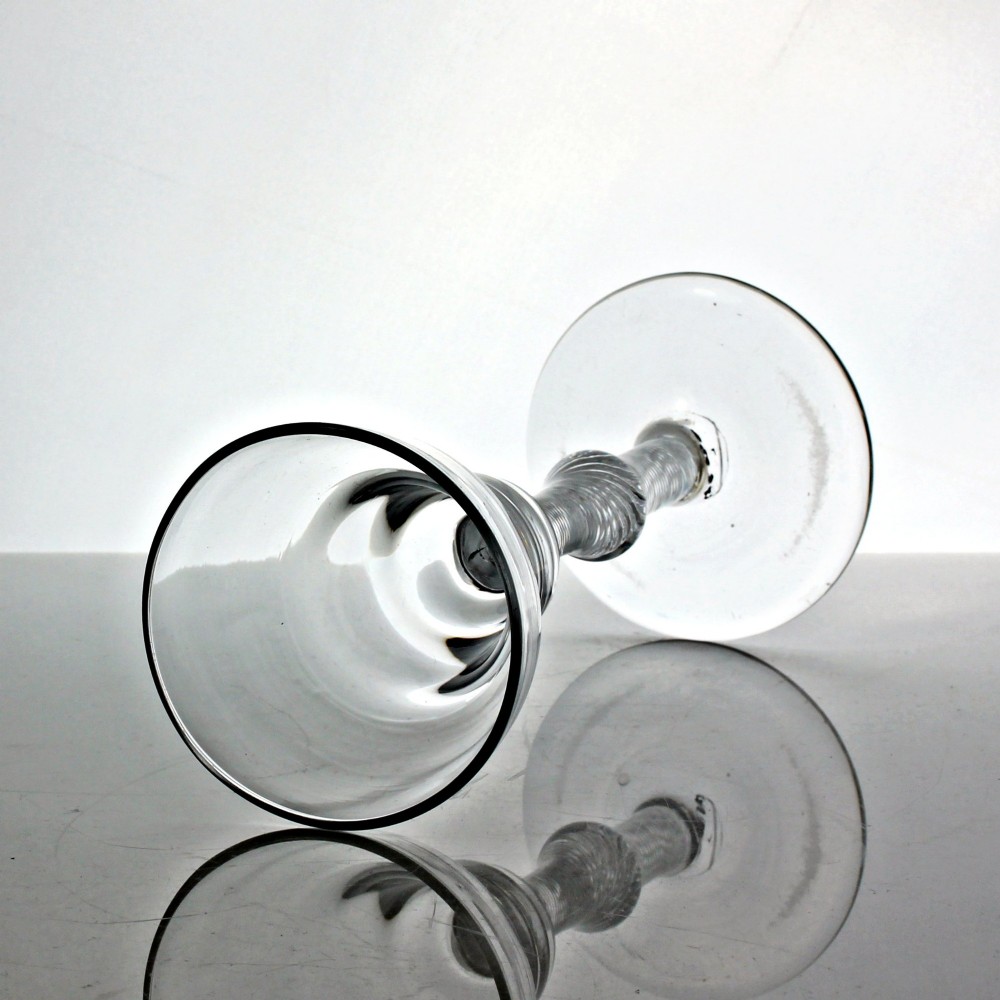A hand-blown Georgian lead glass goblet featuring a pan-top bowl, a multi-spiral air twist stem with a central knop, and a wide conical foot. View II