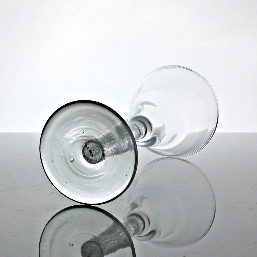 A hand-blown Georgian lead glass goblet featuring a pan-top bowl, a multi-spiral air twist stem with a central knop, and a wide conical foot. View III