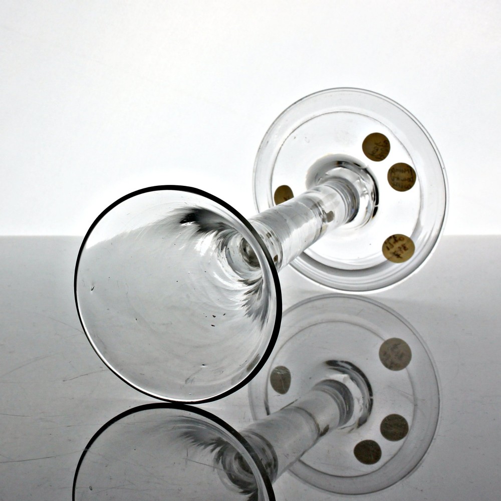 A clear Georgian glass wine goblet featuring a tall trumpet bowl, a solid plain stem, and a wide folded conical foot. View II