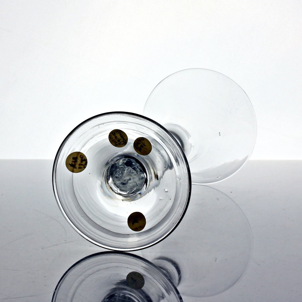 A clear Georgian glass wine goblet featuring a tall trumpet bowl, a solid plain stem, and a wide folded conical foot. View III