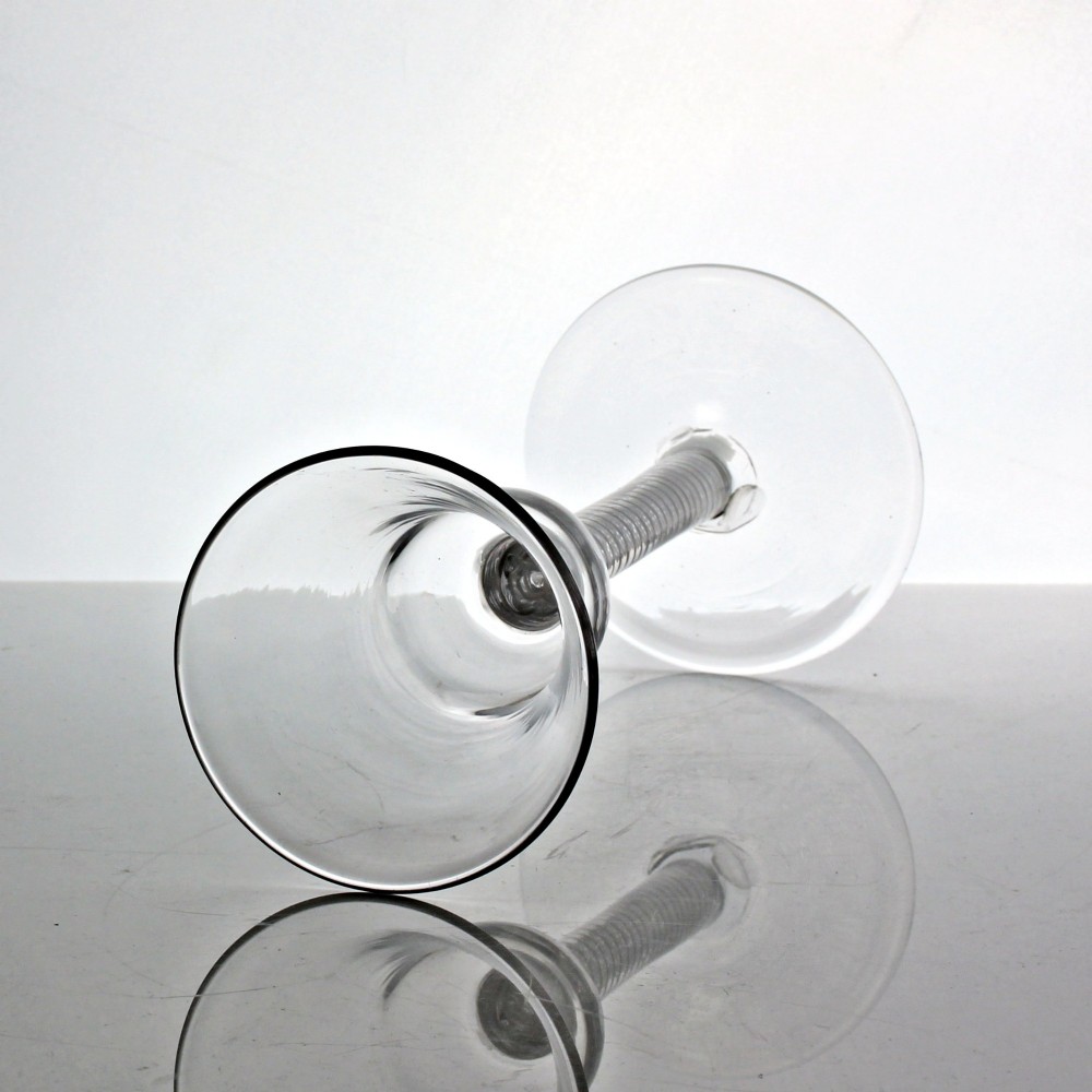 A clear Georgian glass goblet featuring a flared bell bowl resting on a tall mixed-twist stem and circular base. View III