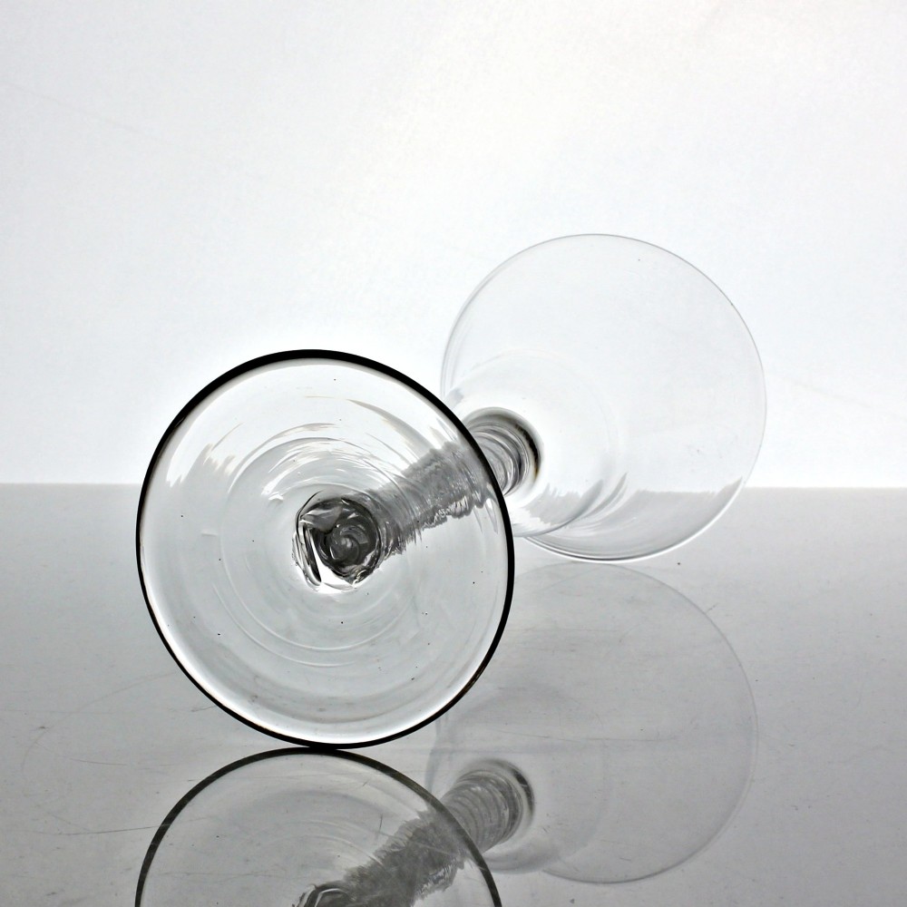 A clear Georgian glass goblet featuring a flared bell bowl resting on a tall mixed-twist stem and circular base. View IV