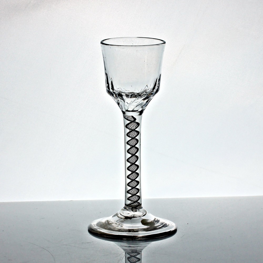 A Georgian clear glass wine goblet featuring a wrythened ogee bowl, a double series opaque twist stem, and a circular conical foot. View II
