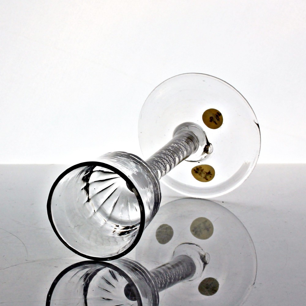 A Georgian clear glass wine goblet featuring a wrythened ogee bowl, a double series opaque twist stem, and a circular conical foot. View III