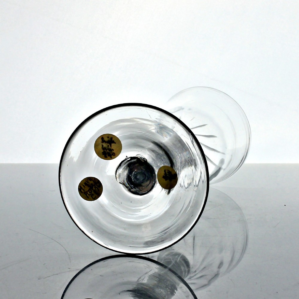 A Georgian clear glass wine goblet featuring a wrythened ogee bowl, a double series opaque twist stem, and a circular conical foot. View IV