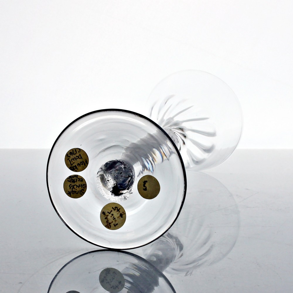 An 18th-century Georgian clear glass wine glass featuring a single series opaque twist stem, a rounded funnel bowl with fluted base, and a conical foot. View IV