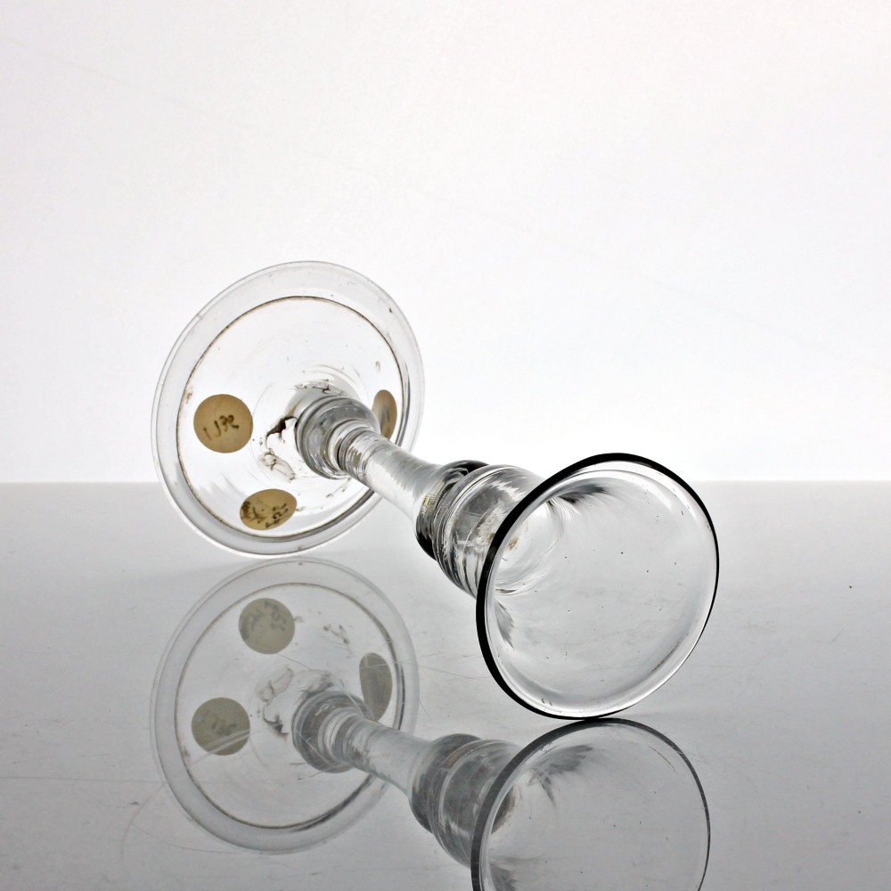 A clear hand-blown Georgian drinking glass featuring a flared bell bowl, a balustroid stem with knops, and a folded conical foot. View II