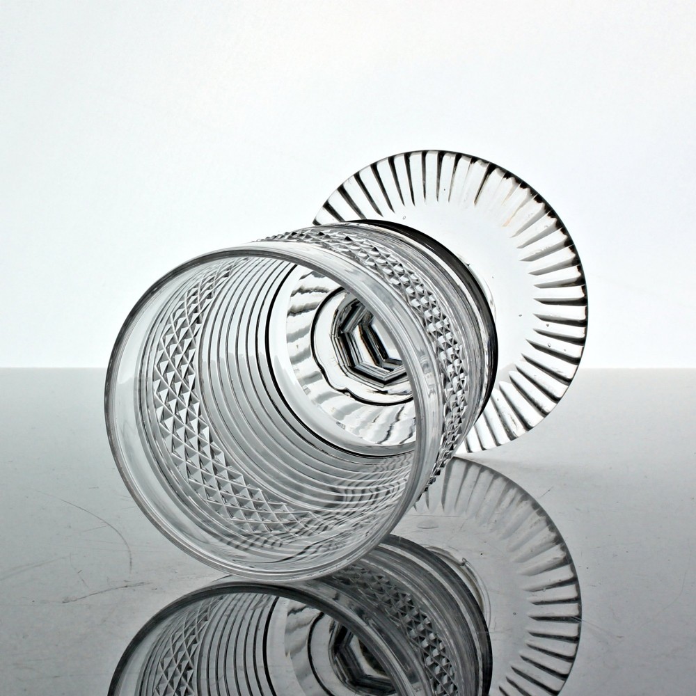 A clear cut glass rummer with a bucket-shaped bowl decorated with diamond cuts and horizontal rings, resting on a faceted stem knop and a circular cut foot. View II