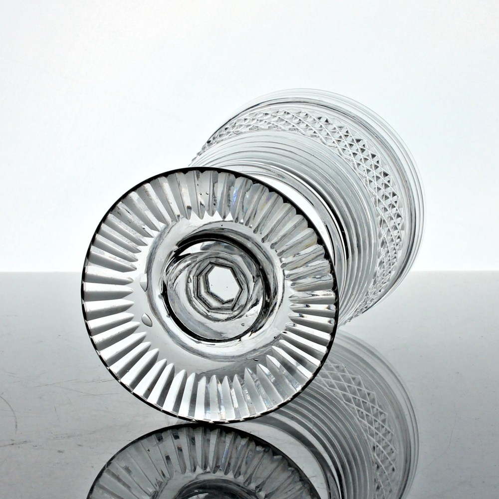 A clear cut glass rummer with a bucket-shaped bowl decorated with diamond cuts and horizontal rings, resting on a faceted stem knop and a circular cut foot. View III