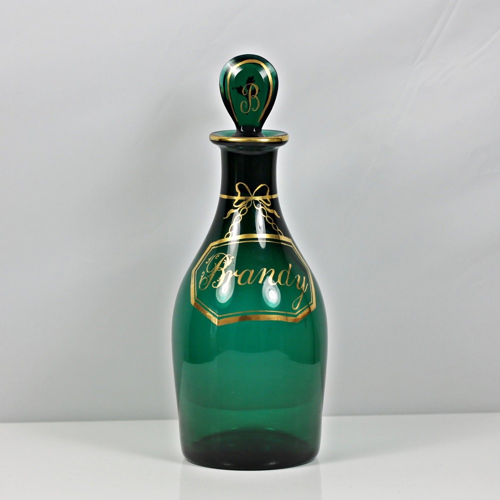 A set of three Georgian Bristol green glass decanters with gilded labels for Brandy, Hollands, and Rum, featuring monograms on the disc stoppers. View II
