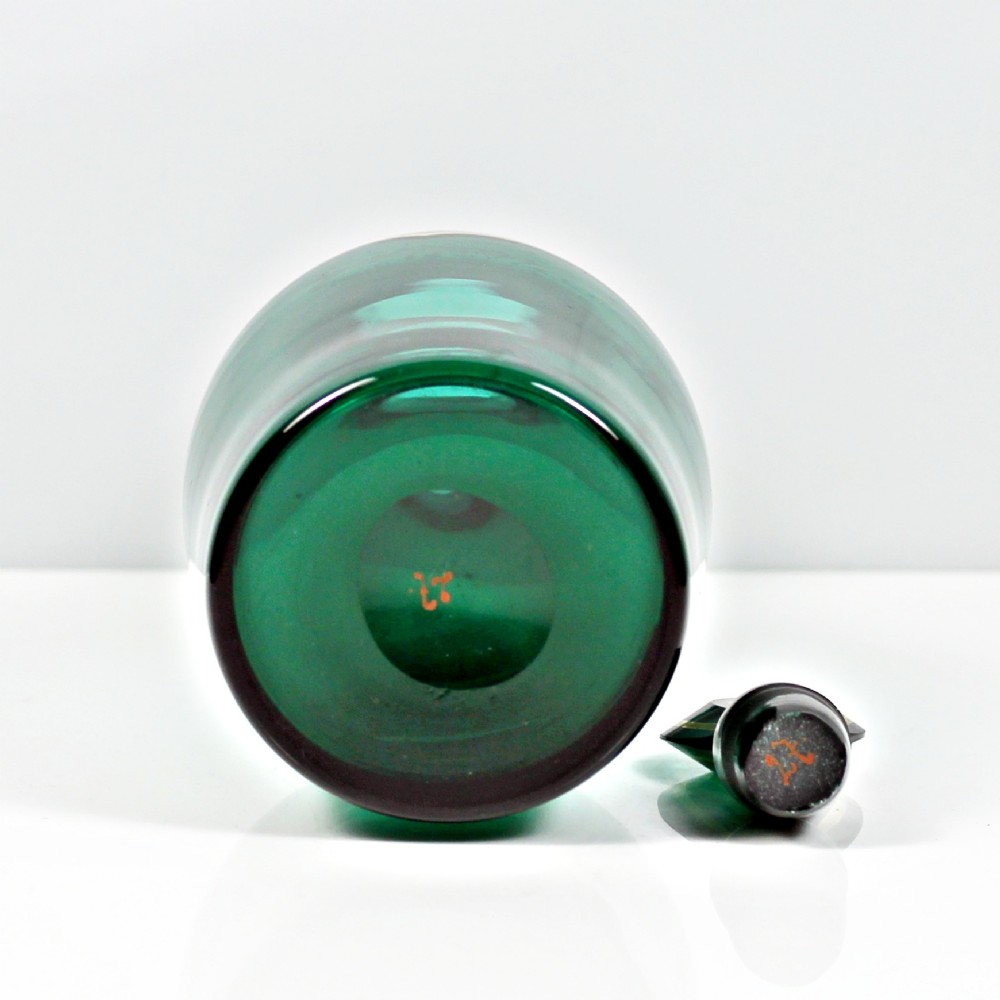 A set of three Georgian Bristol green glass decanters with gilded labels for Brandy, Hollands, and Rum, featuring monograms on the disc stoppers. View VII