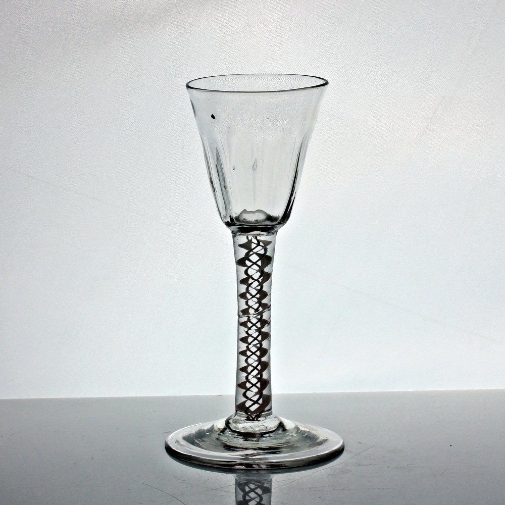 A Georgian clear glass wine glass featuring a flute-moulded rounded funnel bowl, a double series opaque twist stem, and a flat conical foot. View II