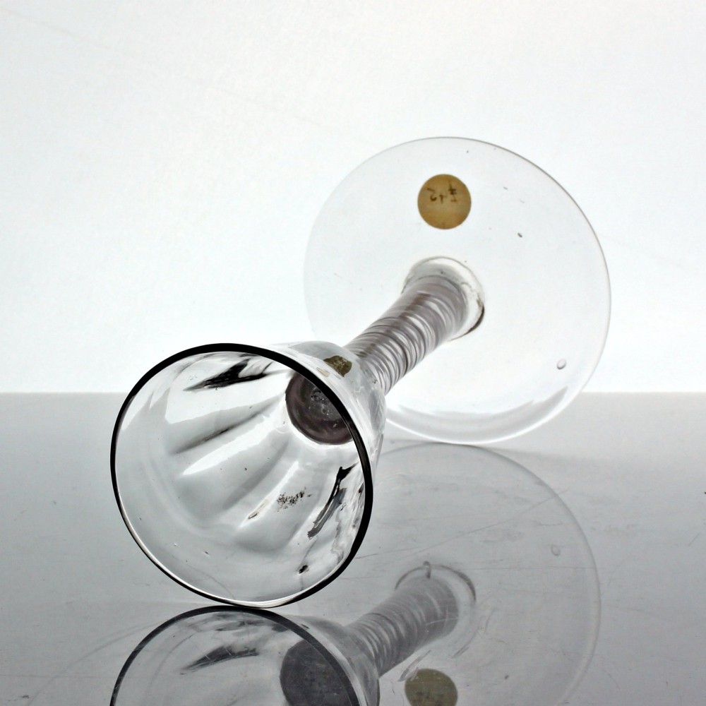 A Georgian clear glass wine glass featuring a flute-moulded rounded funnel bowl, a double series opaque twist stem, and a flat conical foot. View III