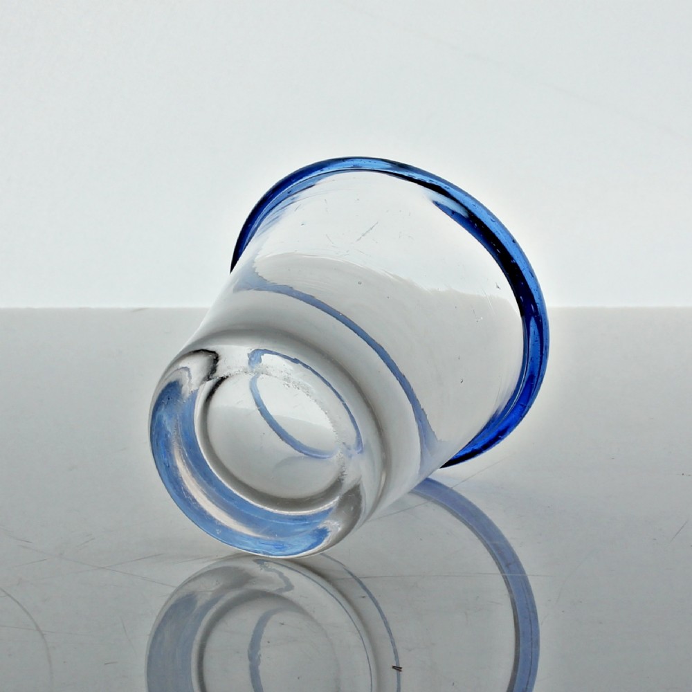 A small clear hand-blown glass tumbler featuring an applied cobalt blue glass rim around the top opening. View III