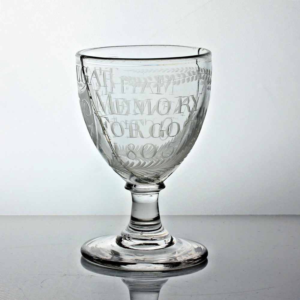 An antique clear glass rummer featuring hand-engraved naval motifs, text referencing Trafalgar, a short stem, and a circular foot. View II