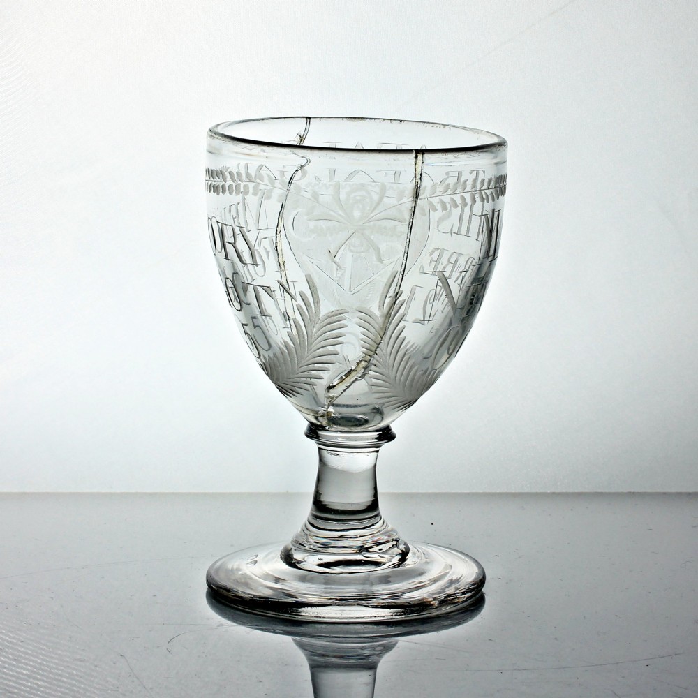 An antique clear glass rummer featuring hand-engraved naval motifs, text referencing Trafalgar, a short stem, and a circular foot. View III