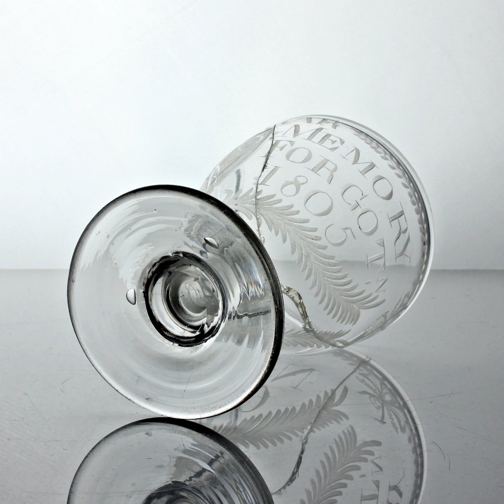 An antique clear glass rummer featuring hand-engraved naval motifs, text referencing Trafalgar, a short stem, and a circular foot. View VI