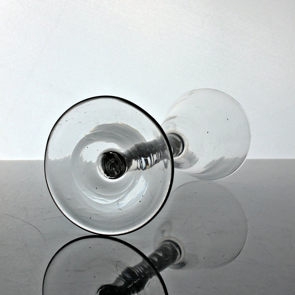 A clear Georgian glass featuring a tall bowl set atop a single series opaque twist stem and a wide circular foot. View III