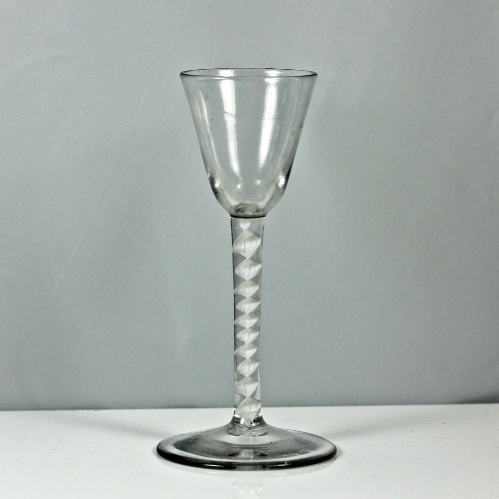 A clear Georgian glass featuring a tall bowl set atop a single series opaque twist stem and a wide circular foot. View IV