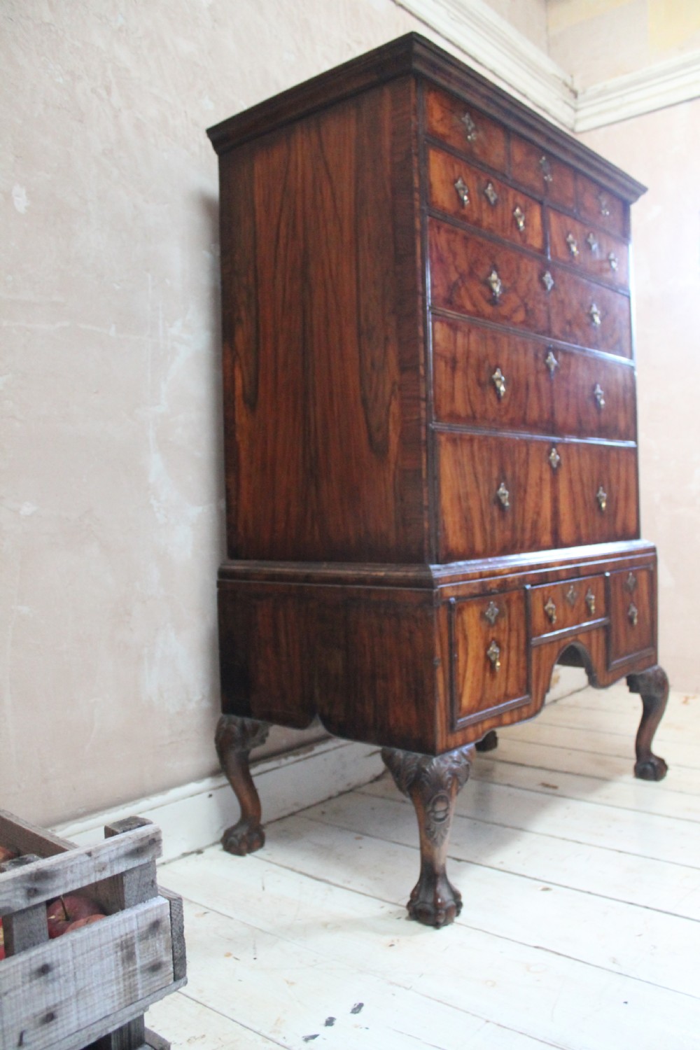 An 18th-century walnut chest on stand featuring figured veneers, brass drop handles, a shaped apron, and cabriole legs with carved knees. View III