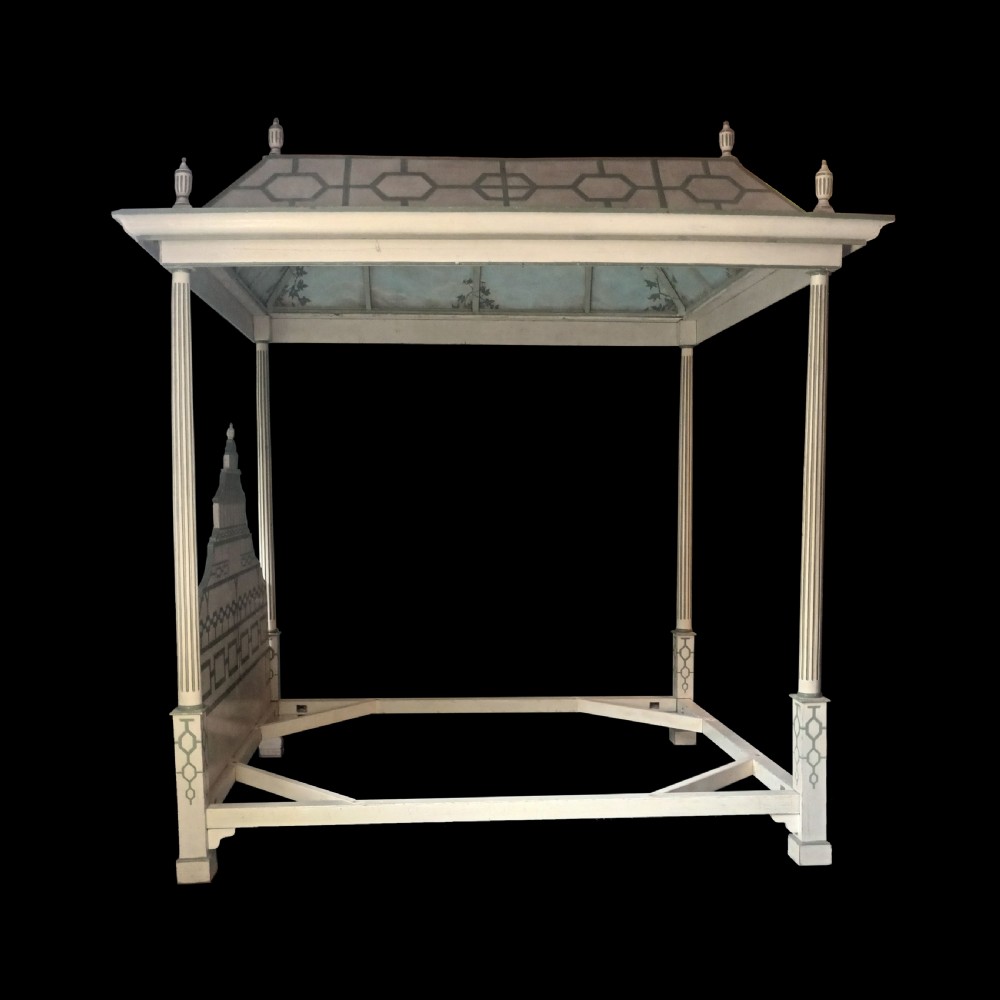 A cream-painted Edwardian four-poster bed frame featuring a pagoda-shaped headboard, decorative geometric fretwork, urn finials, and a painted canopy underside. View II