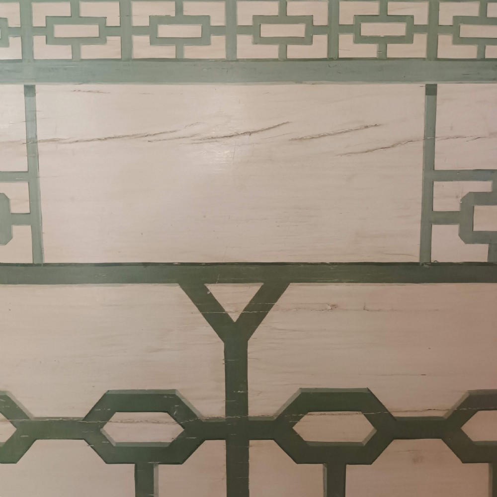 A cream-painted Edwardian four-poster bed frame featuring a pagoda-shaped headboard, decorative geometric fretwork, urn finials, and a painted canopy underside. View IX