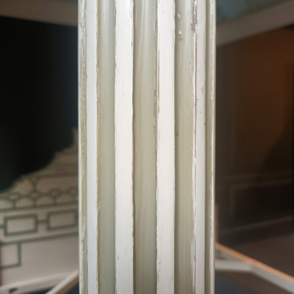 A cream-painted Edwardian four-poster bed frame featuring a pagoda-shaped headboard, decorative geometric fretwork, urn finials, and a painted canopy underside. View XV