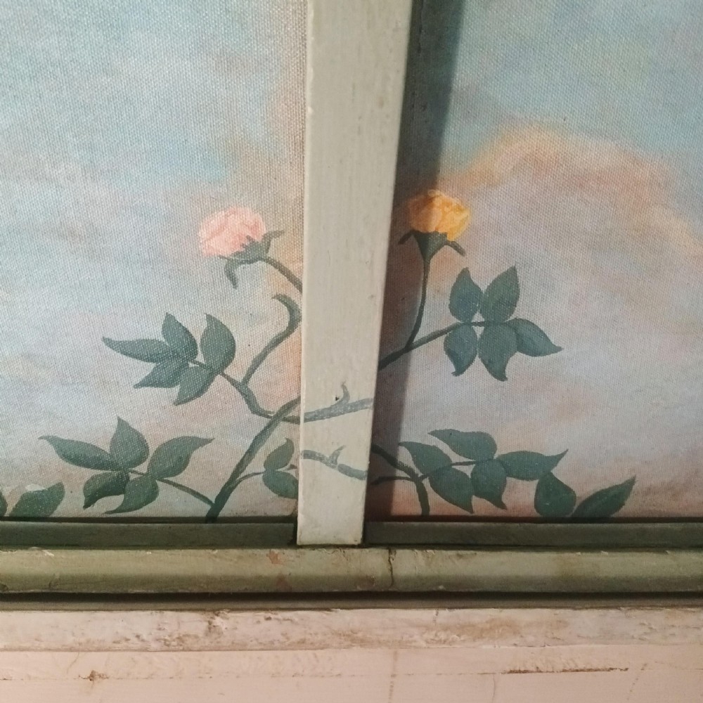 A cream-painted Edwardian four-poster bed frame featuring a pagoda-shaped headboard, decorative geometric fretwork, urn finials, and a painted canopy underside. View XXX