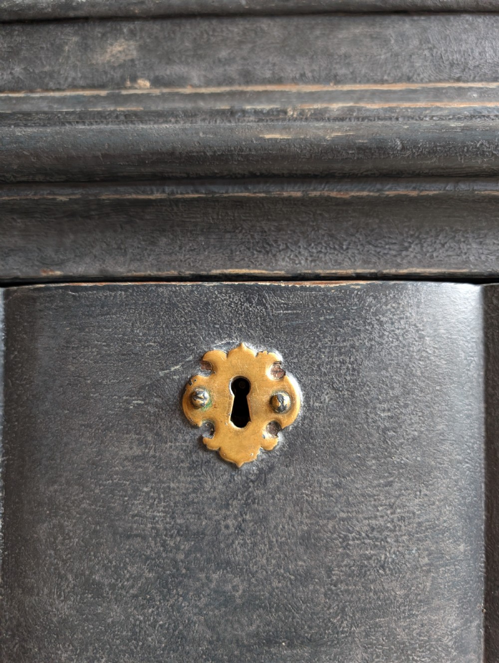 A tall dark grey painted Dutch vitrine cabinet featuring a shaped top hood, glazed upper doors, and three lower drawers with brass handles. View XIV