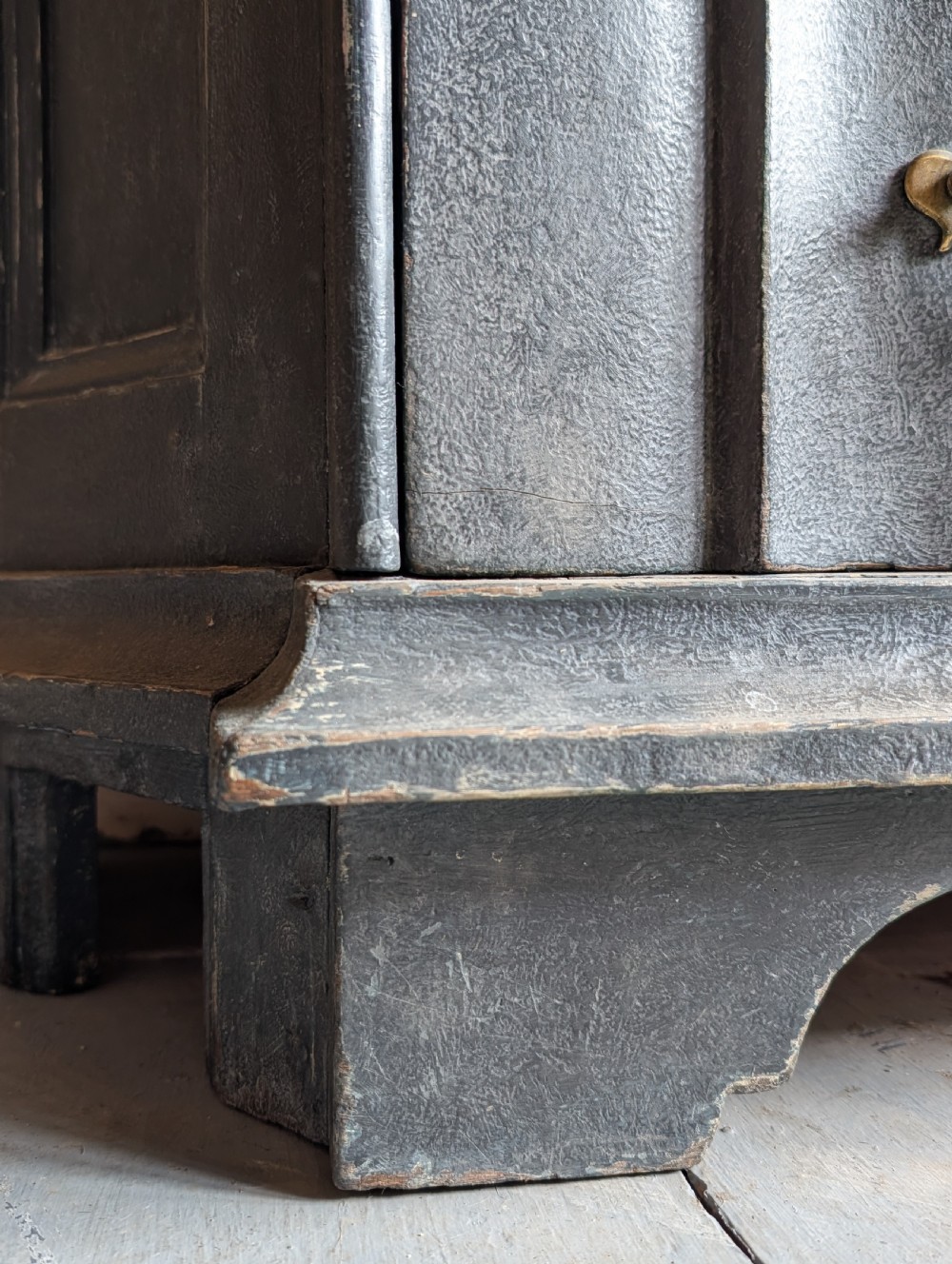 A tall dark grey painted Dutch vitrine cabinet featuring a shaped top hood, glazed upper doors, and three lower drawers with brass handles. View XVI