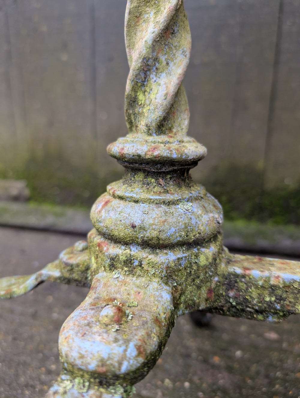 A rectangular grey veined marble top resting on a weathered cast iron base with twisted legs and scroll feet. View VII
