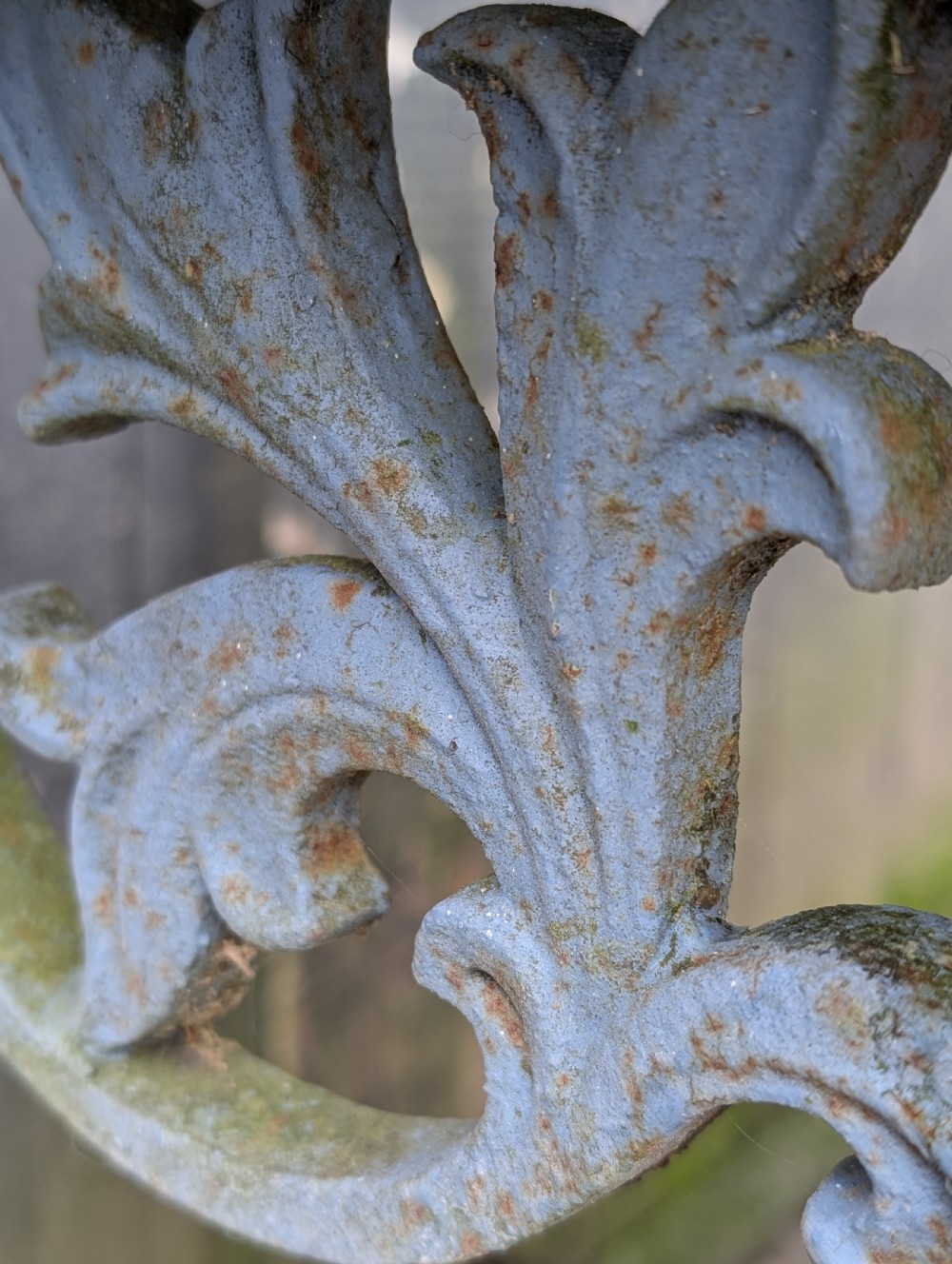 A rectangular grey veined marble top resting on a weathered cast iron base with twisted legs and scroll feet. View IX