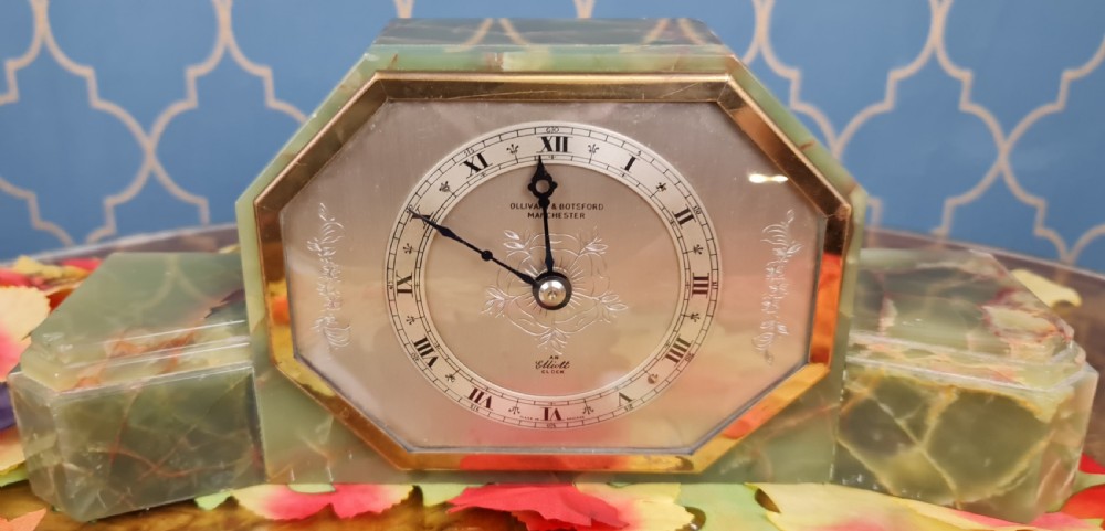 An Art Deco green onyx mantel clock with an octagonal brass-rimmed glass face featuring Roman numerals. View III