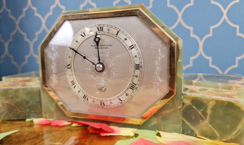 An Art Deco green onyx mantel clock with an octagonal brass-rimmed glass face featuring Roman numerals. View IV