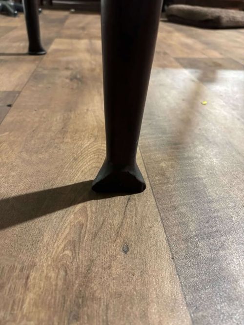fig 3. An antique dark walnut drop leaf table with slender turned legs and side leaves folded down.