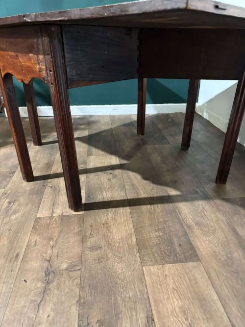 fig 1. A Georgian mahogany drop leaf table with two extended hinged flaps and reeded square legs.