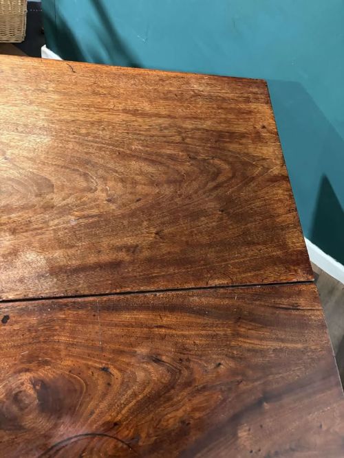 fig 6. A Georgian mahogany drop leaf table with two extended hinged flaps and reeded square legs.