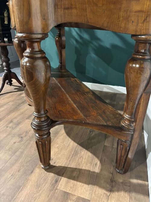 fig 7. A Victorian mahogany console table featuring a serpentine-contoured top, low splashback, turned and fluted legs, and a matching lower tier shelf.