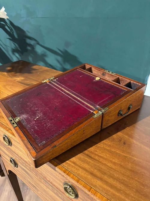fig 2. A rectangular Victorian mahogany writing slope featuring brass side carrying handles and a brass keyhole escutcheon.