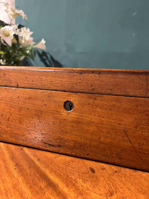 fig 5. A rectangular Victorian mahogany writing slope featuring brass side carrying handles and a brass keyhole escutcheon.