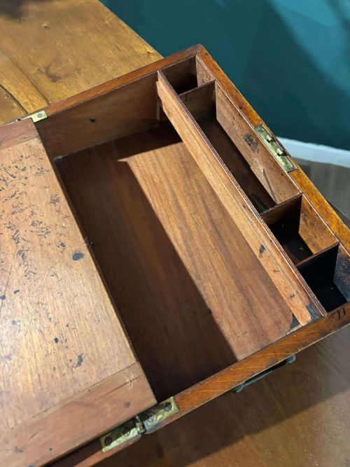 fig 6. A rectangular Victorian mahogany writing slope featuring brass side carrying handles and a brass keyhole escutcheon.