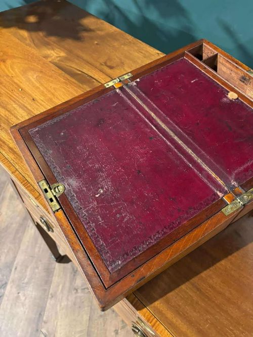 fig 7. A rectangular Victorian mahogany writing slope featuring brass side carrying handles and a brass keyhole escutcheon.