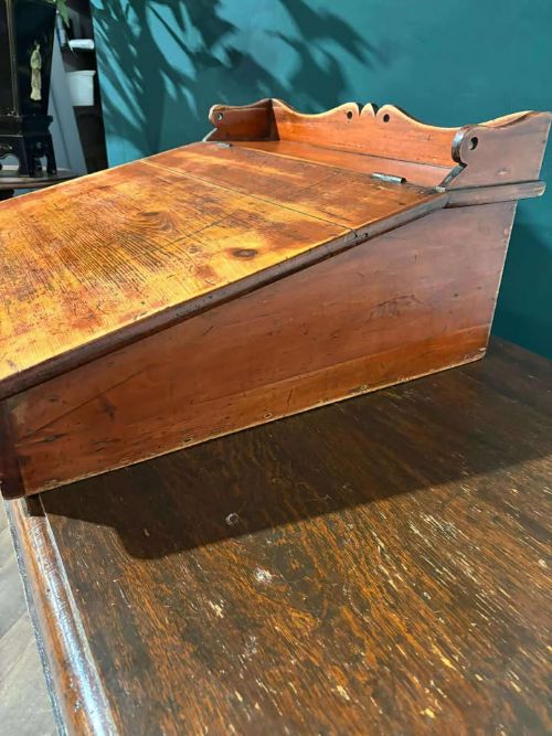 fig 2. A Victorian pine tabletop clerk desk with a slanted hinged lid, front keyhole, and carved decorative gallery back panel.