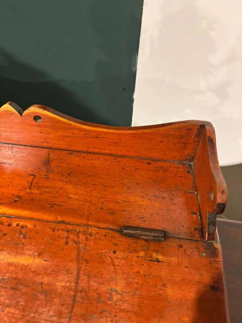 fig 3. A Victorian pine tabletop clerk desk with a slanted hinged lid, front keyhole, and carved decorative gallery back panel.