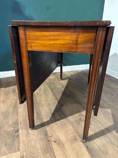 fig 2. A Victorian mahogany drop-leaf gateleg table with two extended leaves, straight legs, and small brass castors.