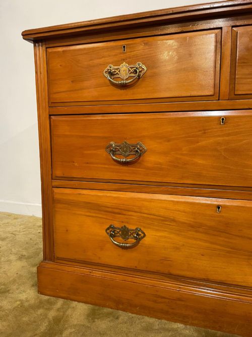 fig 3. An Edwardian satinwood chest of drawers with two short drawers over two long drawers, fitted with brass drop handles and a low rear upstand.