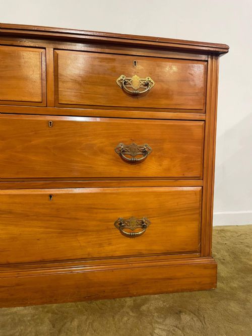 fig 4. An Edwardian satinwood chest of drawers with two short drawers over two long drawers, fitted with brass drop handles and a low rear upstand.