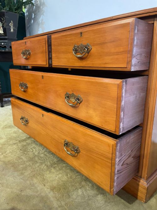 fig 5. An Edwardian satinwood chest of drawers with two short drawers over two long drawers, fitted with brass drop handles and a low rear upstand.
